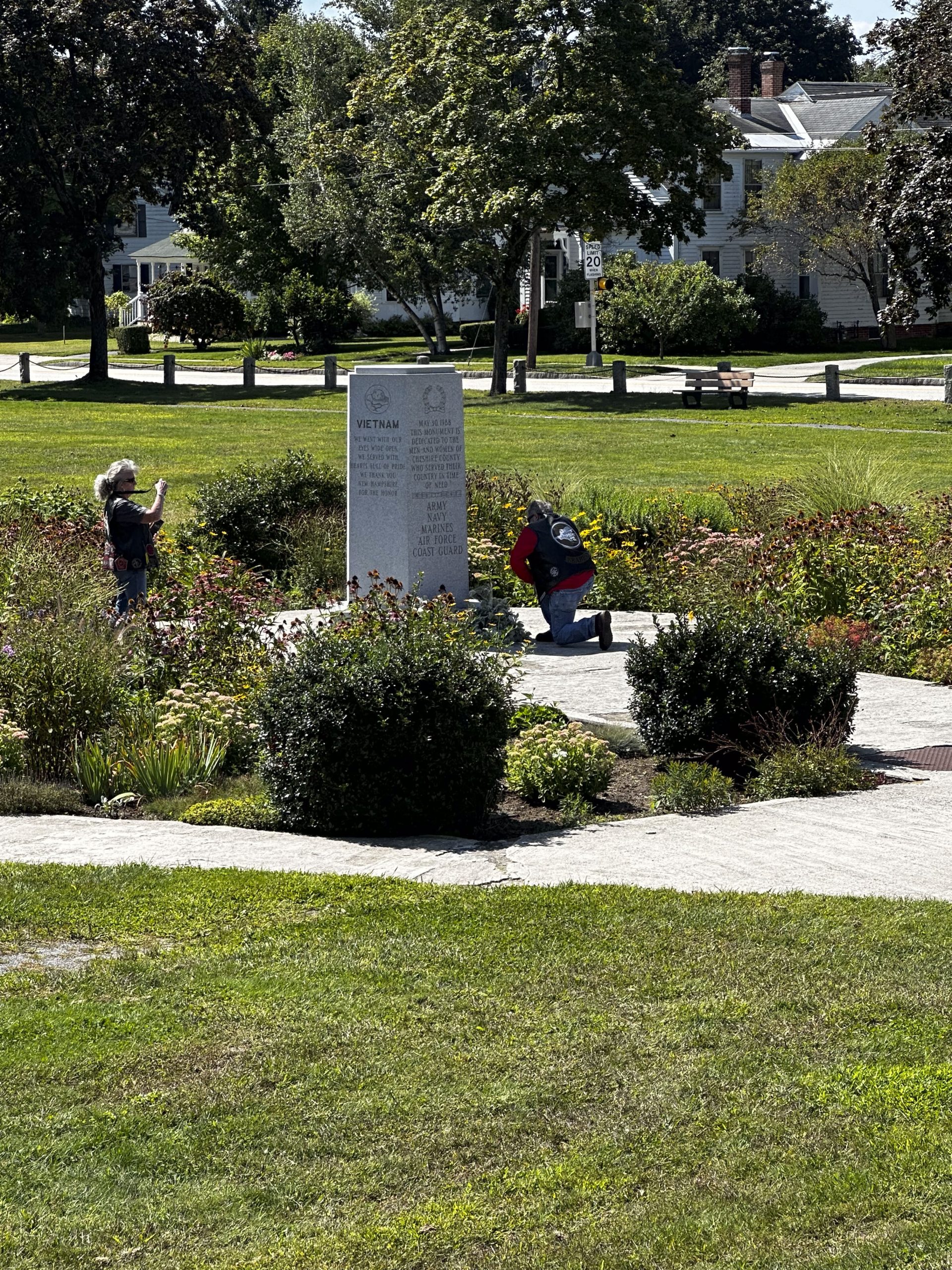 Laying Flowers At The Memorial