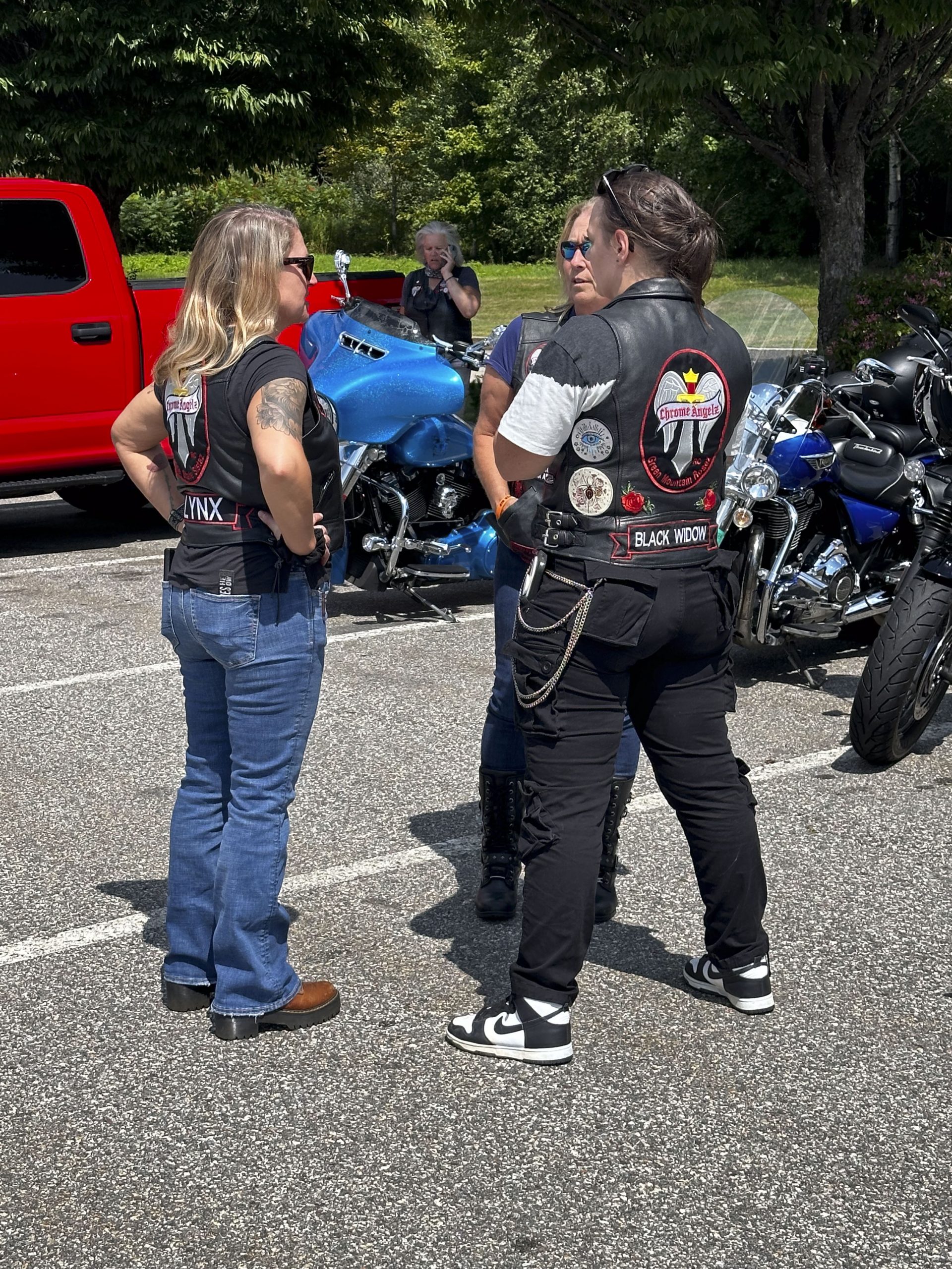 Female riders, the Chrome Angelz confer after the ride